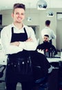 Male hairdresser showing his workplace and tools at hair salon