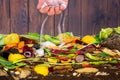 Male hand adding lime to a compost heap to increase the composting rate