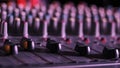 Male Hand Adjusting Faders Up And Down on Audio Mixer in Neon Light Close-Up