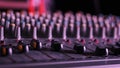 Male Hand Adjusting Faders Up And Down on Audio Mixer in Neon Light Close-Up