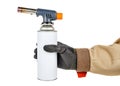 Male hand in black protective glove and brown uniform holding large welding butane torch with white gas bottle isolated on white Royalty Free Stock Photo