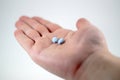 Male hand with blue pills Royalty Free Stock Photo