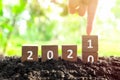 Male hand burying year 2020 to change to 2021 in wooden blocks cubes. New year, hello and goodbye concept. Royalty Free Stock Photo