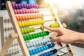 Male hand calculating beads on rainbow abacus Royalty Free Stock Photo