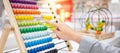 Male hand calculating with beads on rainbow abacus Royalty Free Stock Photo