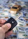 Male hand with car key on the background of dollar bills Royalty Free Stock Photo