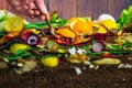 Male hand carefully releasing earthworms lumbricus terrestris on a compost heap Royalty Free Stock Photo