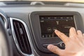 Male hand changing the radio station on car LCD infotainment screen Royalty Free Stock Photo