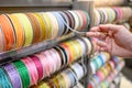 Male hand choosing Ric Rac ribbon in craft shop