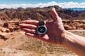 Male hand with compass on background of mountains in summer, point of view. Royalty Free Stock Photo