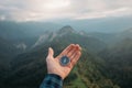 Hand with compass in the mountains. Royalty Free Stock Photo