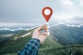 Male hand with compass and GPS route in mountains, pov. Royalty Free Stock Photo