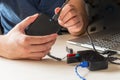 Male hand connecting the hard drive with a USB cable to a laptop computer and USB splitter device Royalty Free Stock Photo