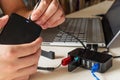 Male hand connecting the hard drive with a USB cable to a laptop computer and USB splitter device Royalty Free Stock Photo