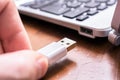 Male Hand Connecting A White USB Cable To The USB Port Of A Small Keyboard Royalty Free Stock Photo