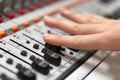 Male hand on control Fader on console. Sound recording studio mixing desk with engineer or music producer. Royalty Free Stock Photo