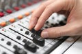 Male hand on control Fader on console. Sound recording studio mixing desk with engineer or music producer. Royalty Free Stock Photo