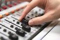 Male hand on control Fader on console. Sound recording studio mixing desk with engineer or music producer. Royalty Free Stock Photo