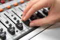 Male hand on control Fader on console. Sound recording studio mixing desk with engineer or music producer. Royalty Free Stock Photo