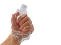 male hand crushing transparent plastic bottle with copy space, fighting against plastic pollution Royalty Free Stock Photo