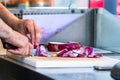 Male hand cutting - chopping red onions, sun light. Royalty Free Stock Photo