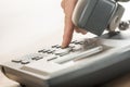 Male hand dialing a classical landline telephone Royalty Free Stock Photo