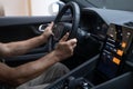 male hand on Driver\'s column, Behind steering wheel Polestar 2 electric car, modern passenger car, showcasing interior
