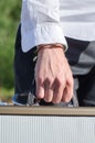 Male hand enchained to suitcase