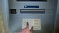 Male hand entering pin code on ATM to withdraw money cash, top view, banking Royalty Free Stock Photo