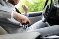 Male hand fastens seat belt in car. Buckle seat belt while sitting inside car before driving