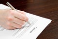 Male hand filling out and signing contract Royalty Free Stock Photo