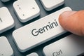 Male hand finger pressing Gemini key on keyboard. New AI model of Google which understands text, images, video and speech Royalty Free Stock Photo