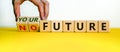 Male hand flips wooden cubes and changes the inscription `no future` to `your future`. Beautiful yellow table, white backgroun Royalty Free Stock Photo