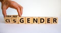 Male hand flips wooden cubes and changes word 'cisgender' to 'transgender'. Beautiful white