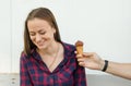 Male hand gives ice cream to smiling girl with long hair and freckles