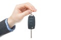 Male hand giving car keys - studio shot isolated on white background