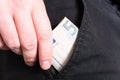 Male Hand Grabbing A 50 Euro Bill Out Of The Pocket Of A Black Jeans Trouser- Poor Man Concept Royalty Free Stock Photo