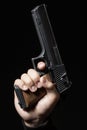 Male hand with gun isolated on black Royalty Free Stock Photo