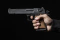 Male hand with gun isolated on black Royalty Free Stock Photo