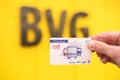 male hand hold electronic Deutschland-Ticket, BVG logo Berliner Transport services main public transport carrier in Berlin, travel