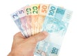 Male hand holding all brazilian reais notes Royalty Free Stock Photo