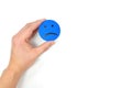 Male hand holding a blue sad face icon in white background with copy space. Sadness and loneliness concept.