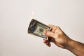 Male hand holding burning dollar money on white background Royalty Free Stock Photo