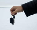 Male hand holding car key and alarm system charm Royalty Free Stock Photo