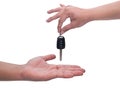 Male hand holding a car key and handing it over to another person isolated Royalty Free Stock Photo