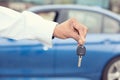 Male hand holding car keys offering new car Royalty Free Stock Photo