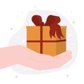 Male hand holding christmas or birthday gift. Cartoon holiday box with ribbon and bow. Present giving and gifting Royalty Free Stock Photo