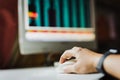 Male hand holding computer mouse with PC screen in background. Royalty Free Stock Photo