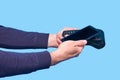 Male hand holding a credit card payment terminal on a blue background Royalty Free Stock Photo