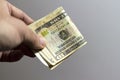 Male hand holding a dollars banknotes. Selective focus of a man with American money closeup Royalty Free Stock Photo